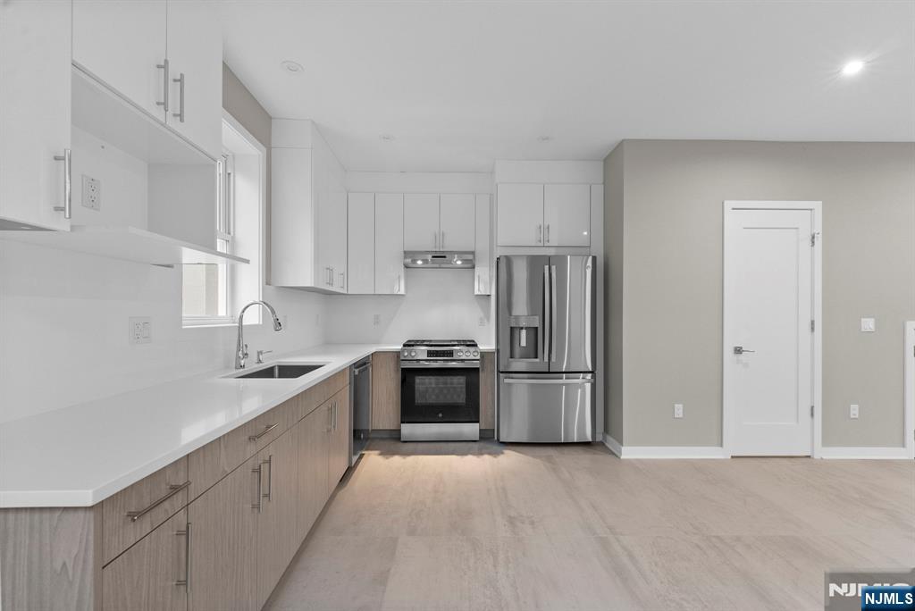 743 Kingsland Avenue, Unit 1 Ridgefield, NJ 07657 - Photo 8 of 27 a kitchen with stainless steel appliances granite countertop a refrigerator sink and stove