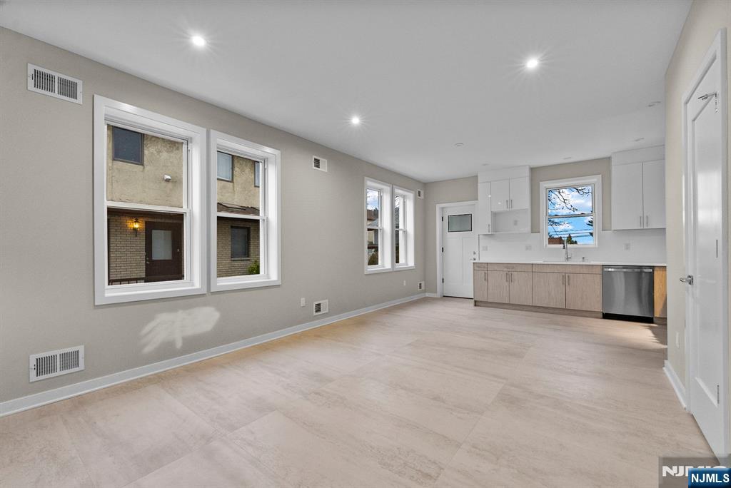 743 Kingsland Avenue, Unit 1 Ridgefield, NJ 07657 - Photo 10 of 27 a view of a big room with windows and cabinet