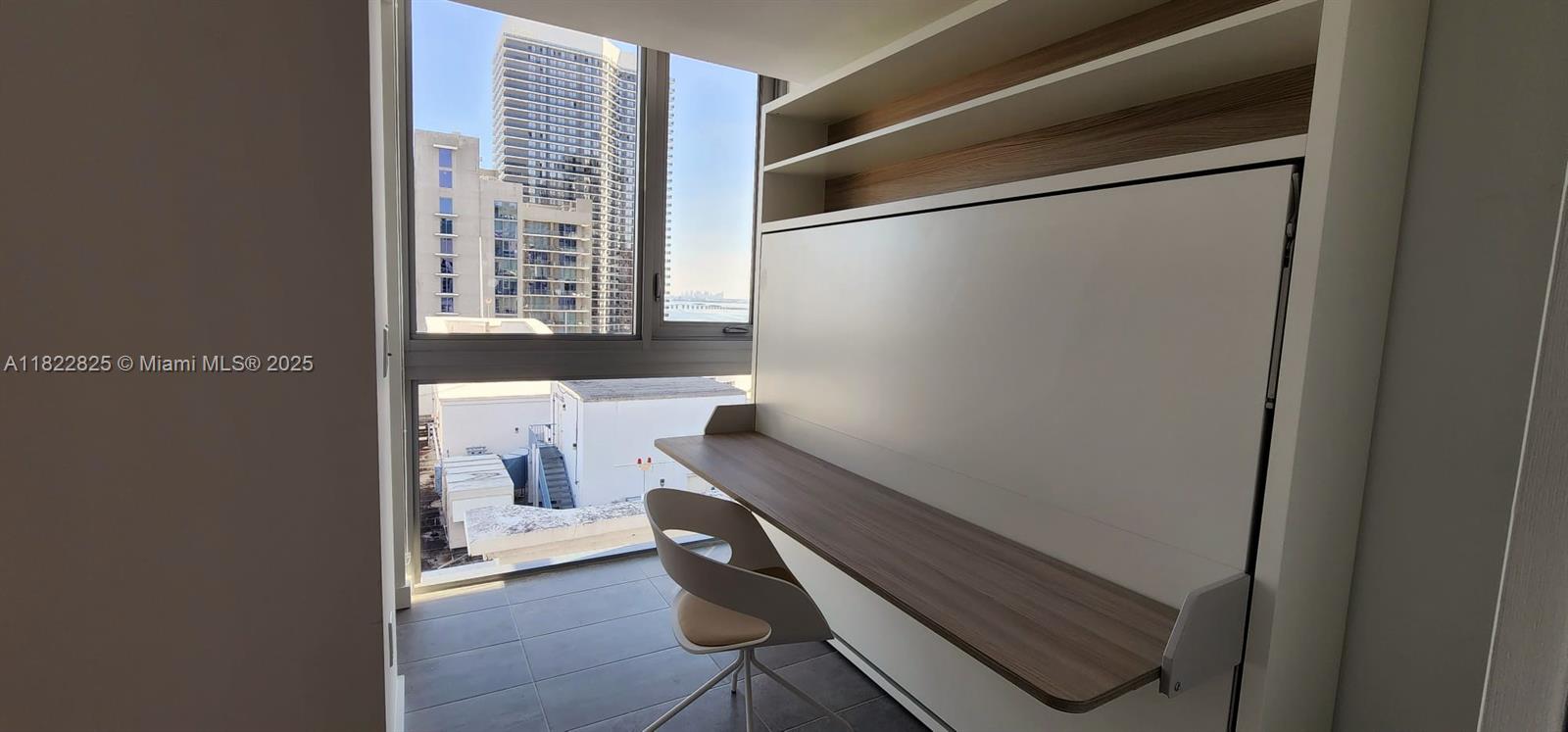 227 Northeast 2nd Street, Unit 2907 Miami, FL 33132 - Photo 14 of 36 a room with a chair and a window