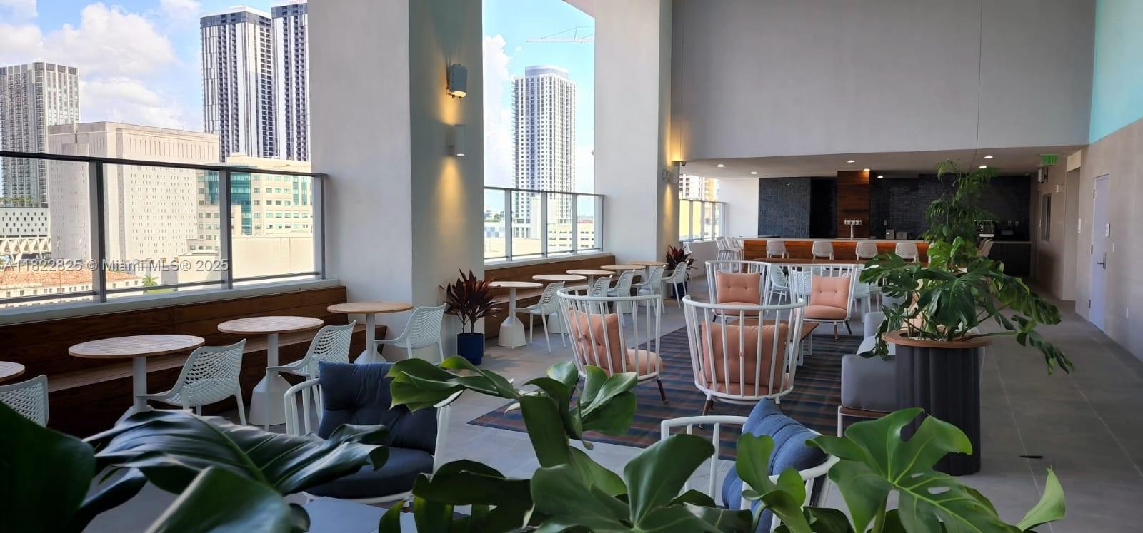 227 Northeast 2nd Street, Unit 2907 Miami, FL 33132 - Photo 19 of 36 a lobby with furniture and potted plants