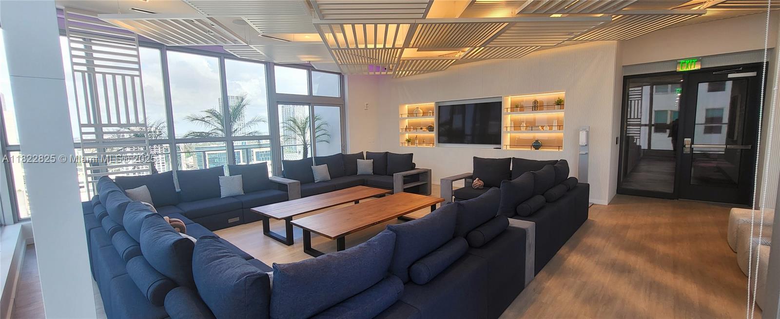 227 Northeast 2nd Street, Unit 2907 Miami, FL 33132 - Photo 32 of 36 a living room with furniture and a flat screen tv