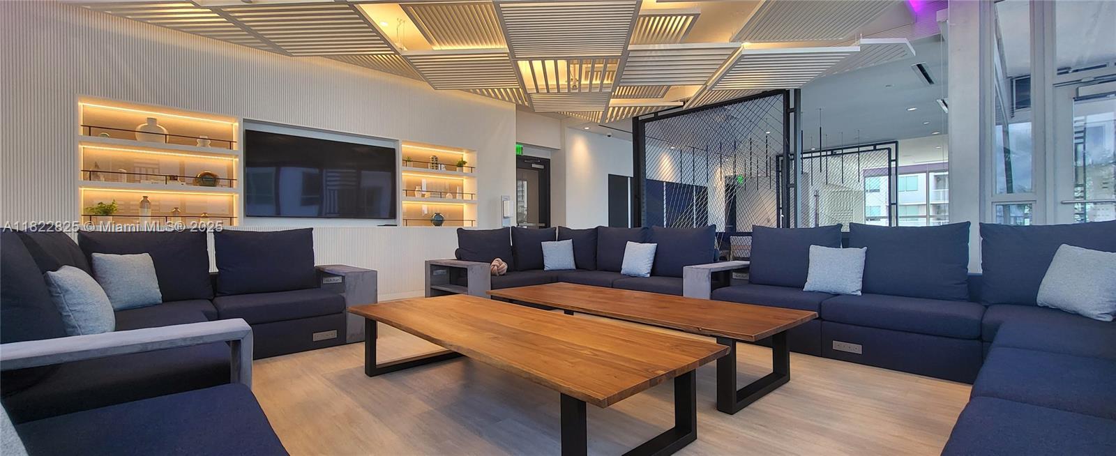 227 Northeast 2nd Street, Unit 2907 Miami, FL 33132 - Photo 33 of 36 a living room with furniture a flat screen tv and windows