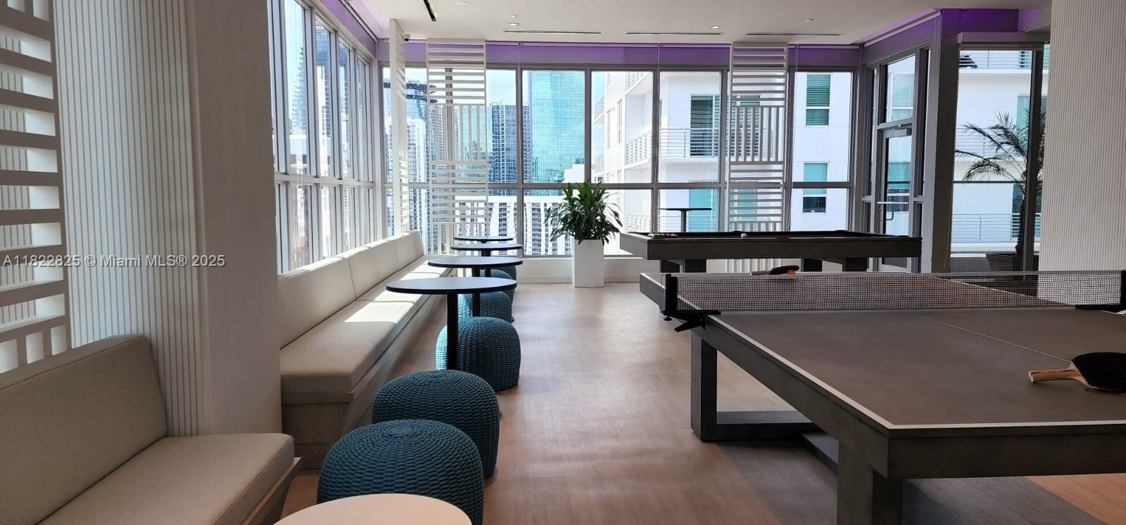 227 Northeast 2nd Street, Unit 2907 Miami, FL 33132 - Photo 34 of 36 a living room with furniture and a floor to ceiling window