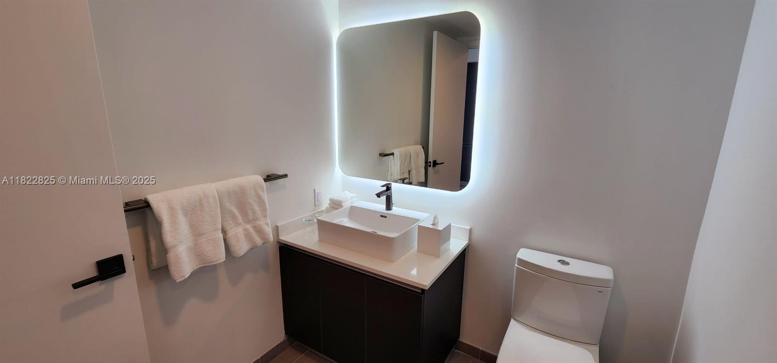 227 Northeast 2nd Street, Unit 2907 Miami, FL 33132 - Photo 10 of 36 a bathroom with a sink and mirror