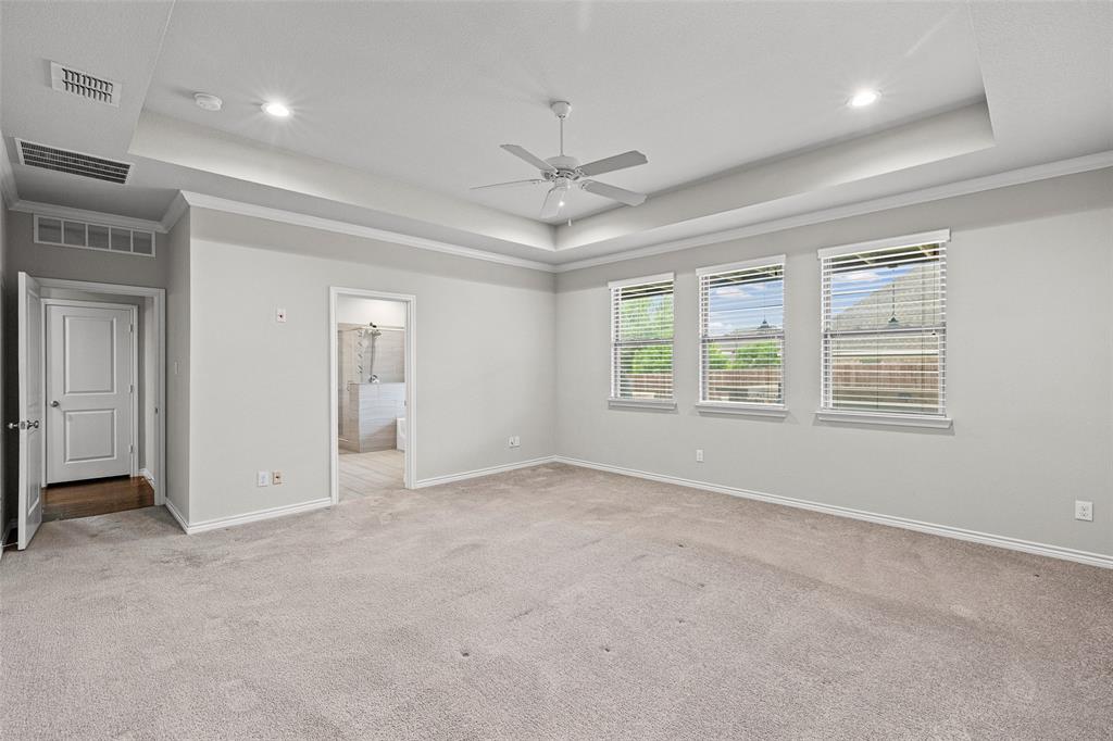 437 Prairie Run Aledo, TX 76008 - Photo 16 of 33 Spacious room featuring light gray carpeting, a tray ceiling with recessed lighting and a ceiling fan, and three windows with blinds