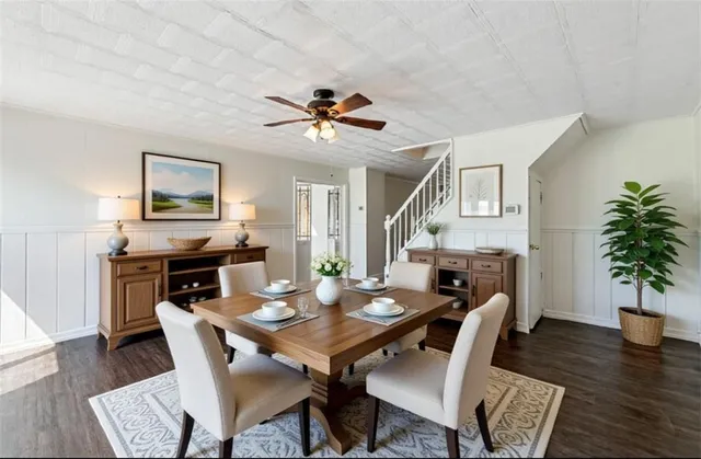 a bathroom with a double vanity sink and mirror with bathtub