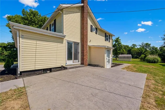 a front view of a house with potted plants