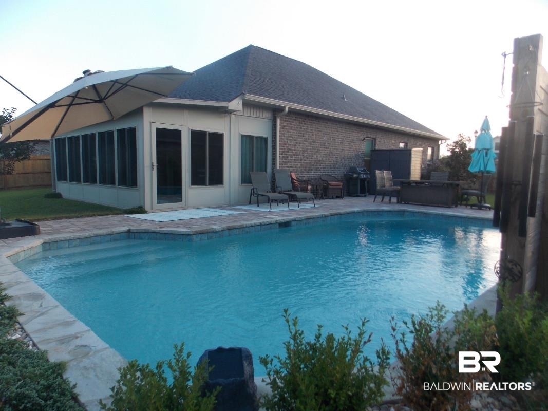 1121 Stella Road Foley, AL 36535 - Photo 19 of 22 View of pool with area for grilling and a patio
