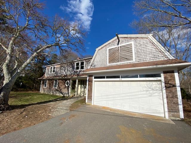 10 Arbor Way Hyannis, MA 02601 - Photo 2 of 17 a front view of a house with a garage