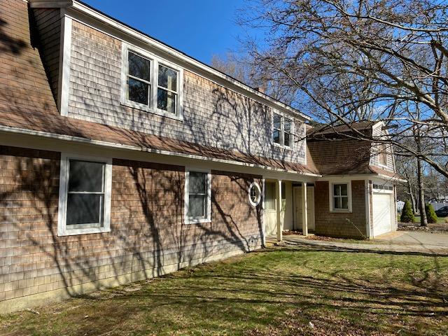10 Arbor Way Hyannis, MA 02601 - Photo 3 of 17 a front view of a house with a garden