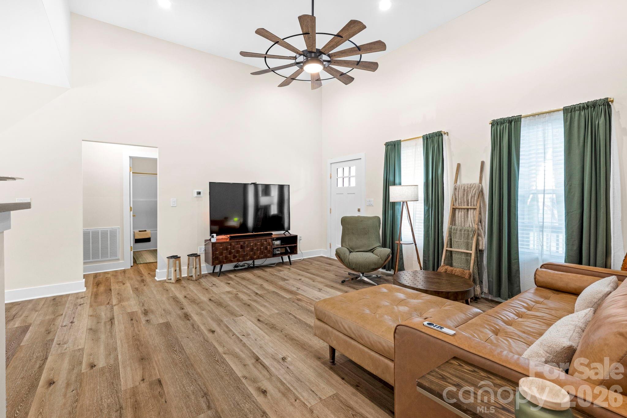 2462 Shoal Road Crouse, NC 28033 - Photo 13 of 35 a living room with furniture a flat screen tv and a large window