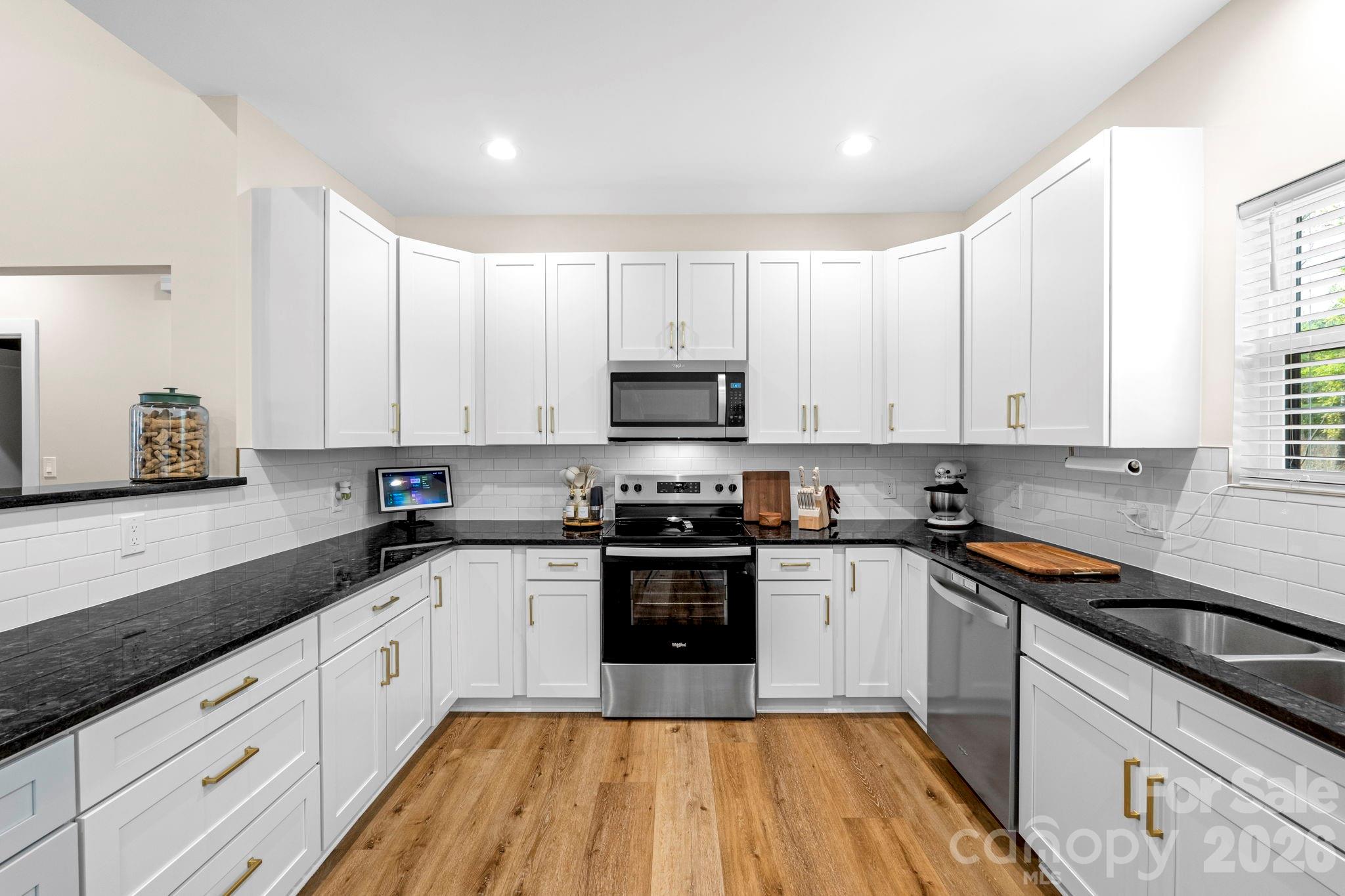 2462 Shoal Road Crouse, NC 28033 - Photo 15 of 35 a kitchen with granite countertop white cabinets and stainless steel appliances