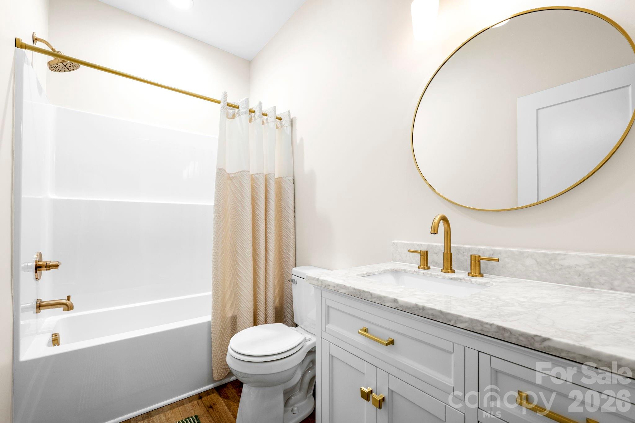 2462 Shoal Road Crouse, NC 28033 - Photo 32 of 35 a bathroom with a sink a toilet and a mirror