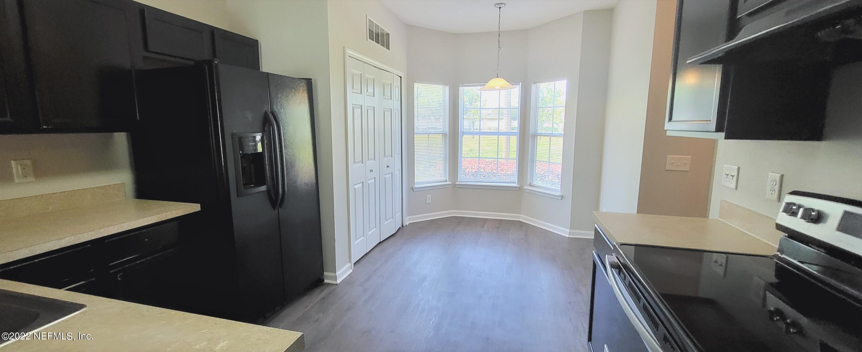 640 Wishing Way Orange Park, FL 32073 - Photo 2 of 10 a kitchen with a refrigerator and a stove top oven