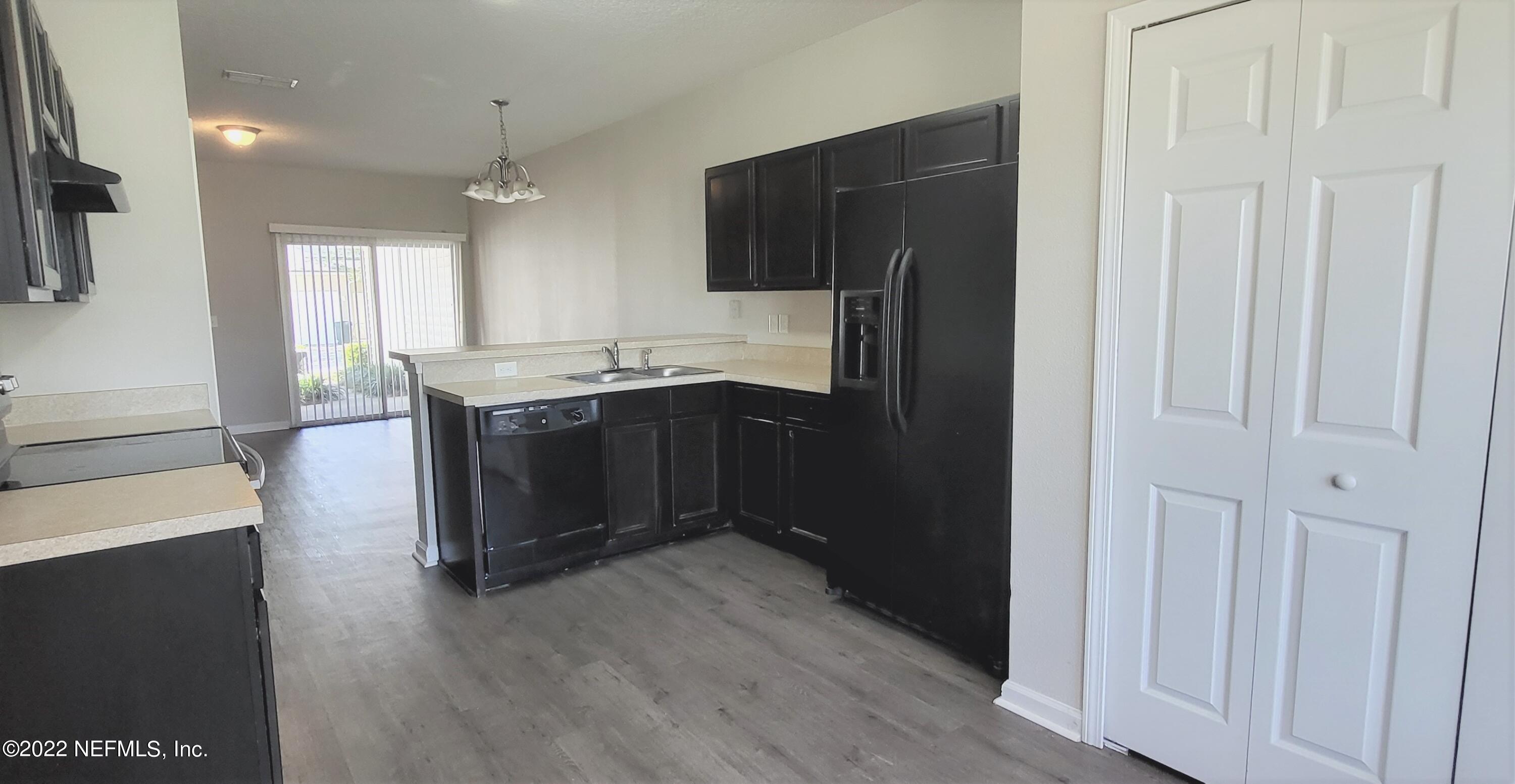 640 Wishing Way Orange Park, FL 32073 - Photo 3 of 10 a kitchen with stainless steel appliances granite countertop a refrigerator and a sink