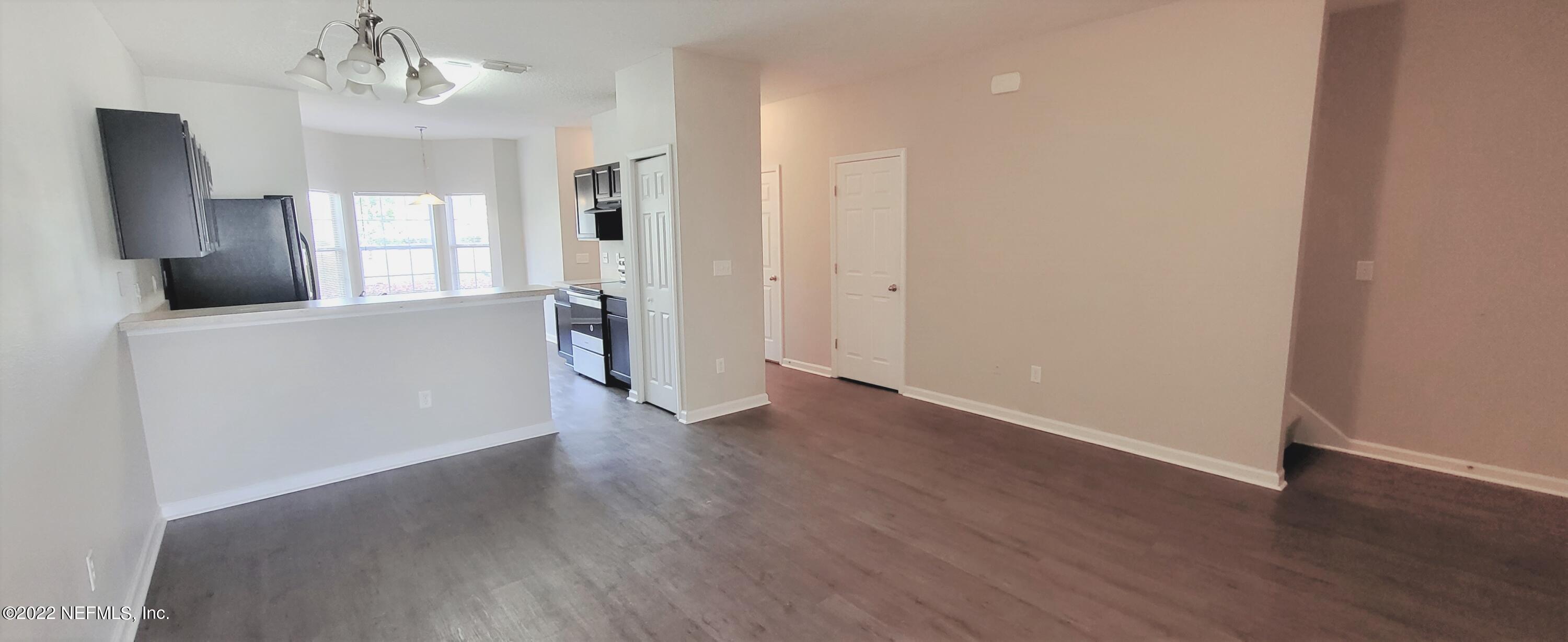 640 Wishing Way Orange Park, FL 32073 - Photo 5 of 10 wooden floor in an empty room with a window