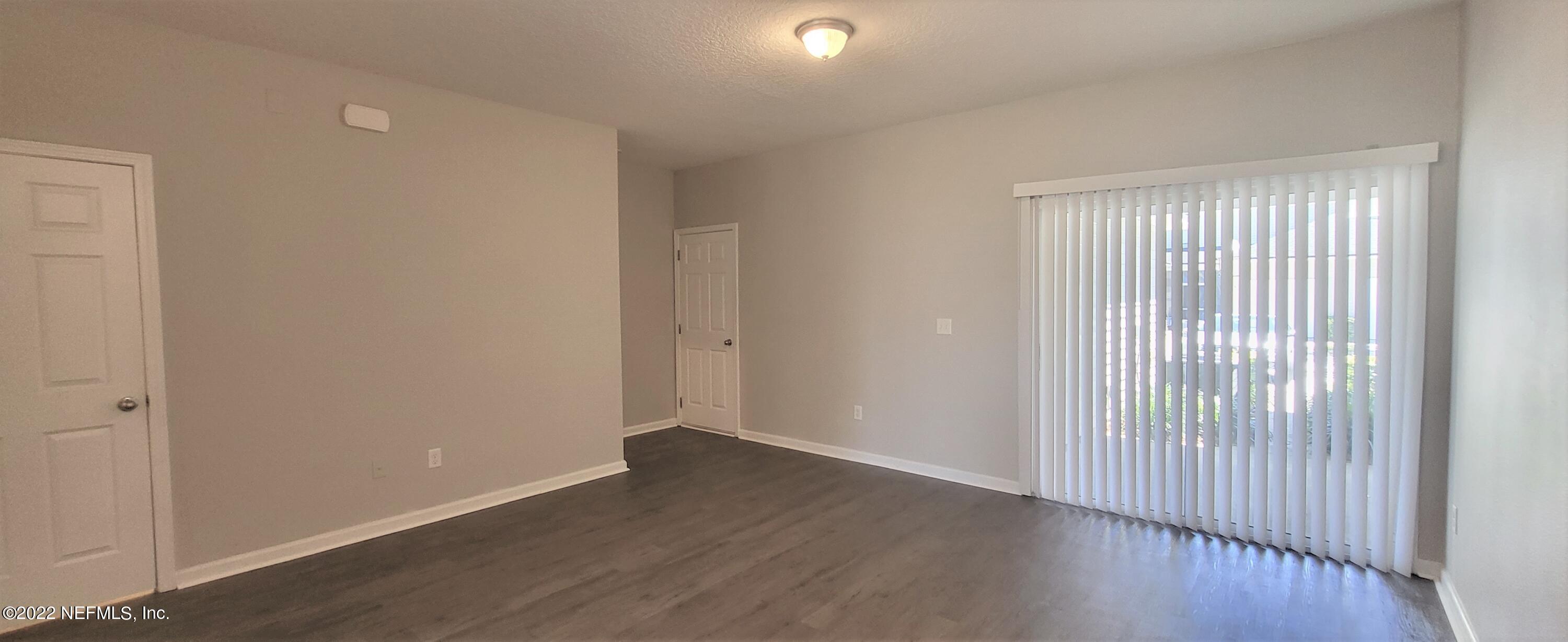 640 Wishing Way Orange Park, FL 32073 - Photo 6 of 10 a view of an empty room with wooden floor