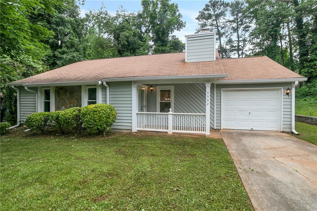 3942 Springleaf Point Stone Mountain, GA 30083 - Photo 1 of 1 a backyard of a house with large trees