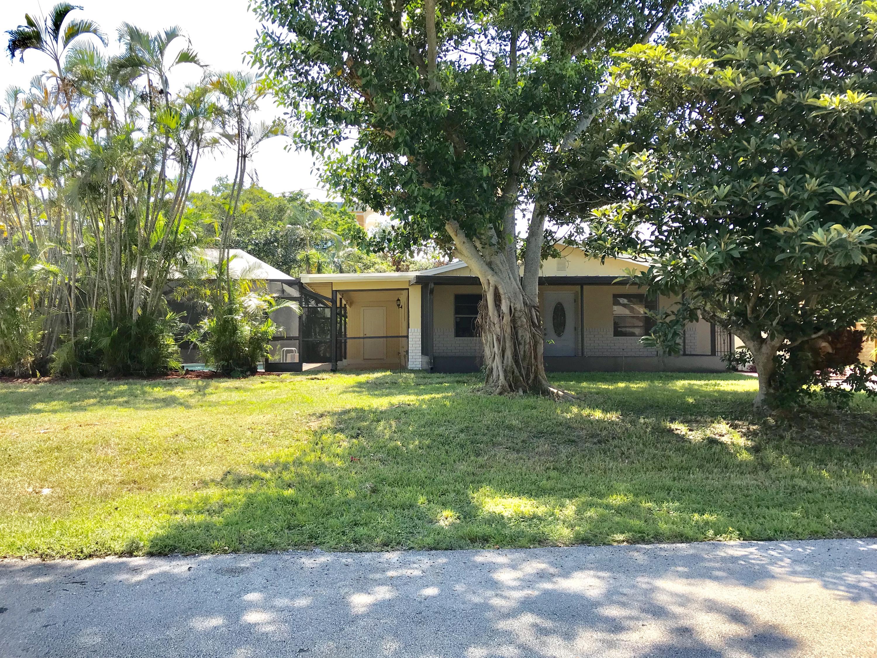 14827 Whatley Road Delray Beach, FL 33445 - Photo 3 of 36 a front view of house with yard and green space