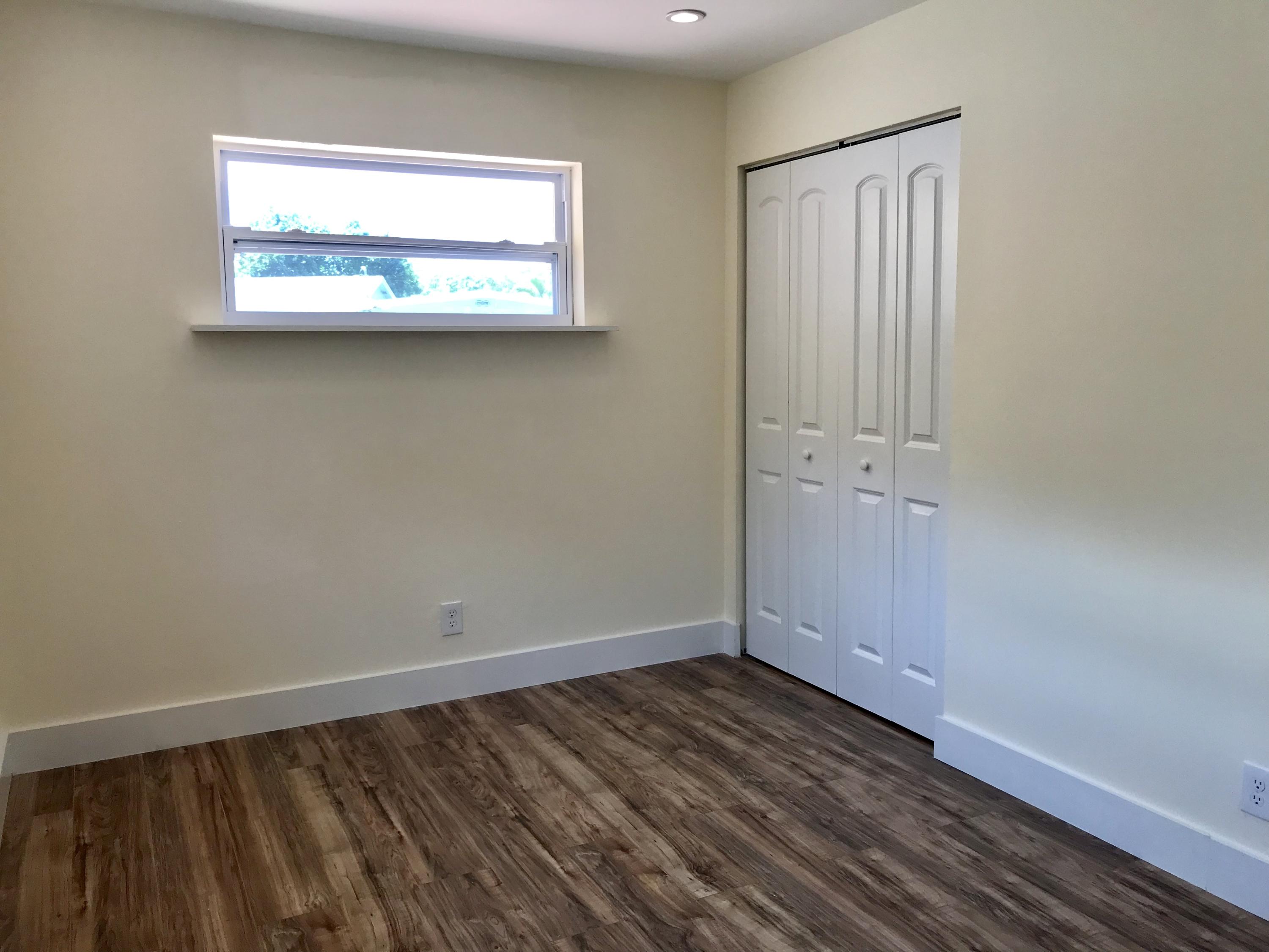 14827 Whatley Road Delray Beach, FL 33445 - Photo 32 of 36 a view of an empty room with wooden floor and a window