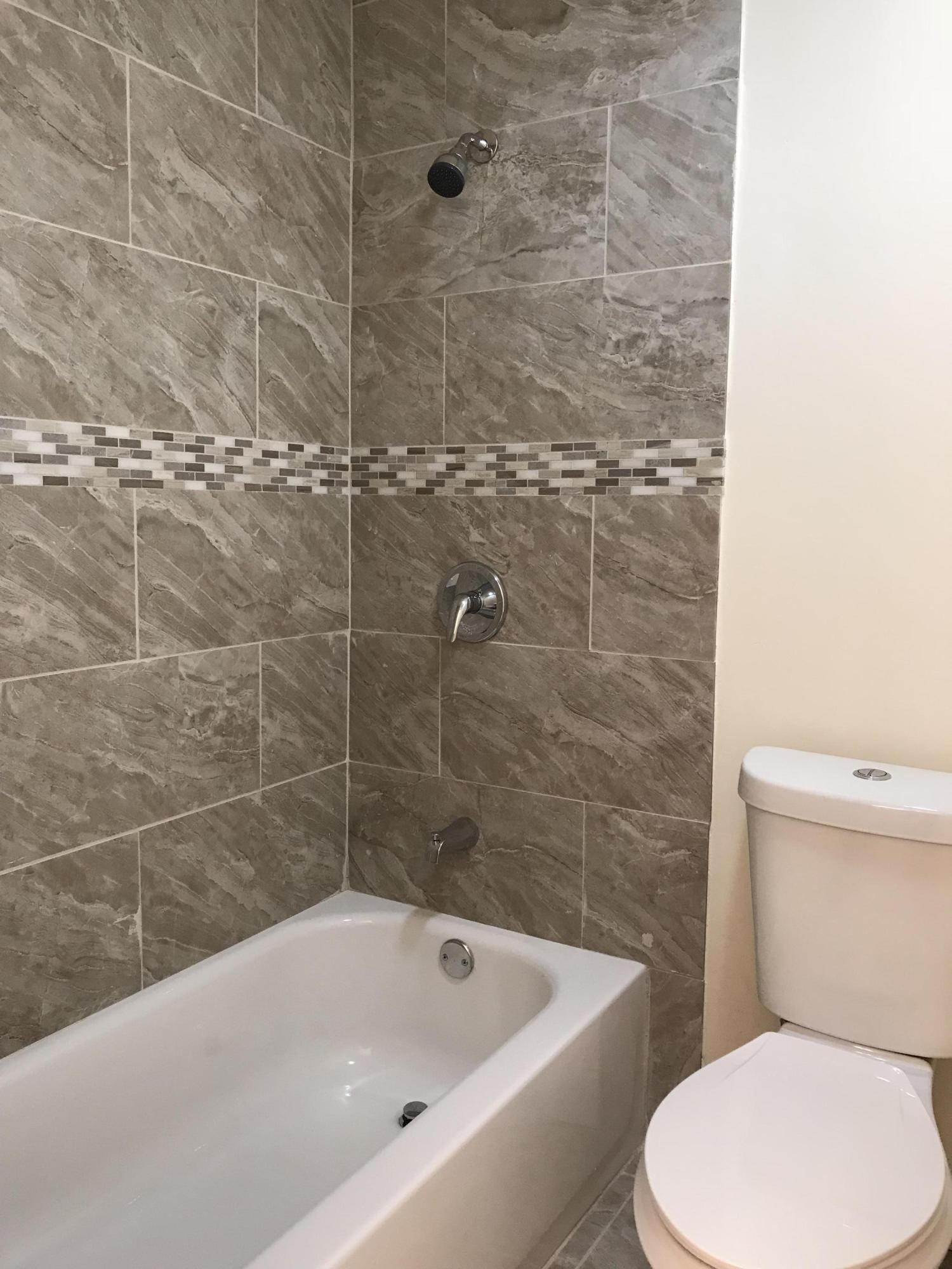 14827 Whatley Road Delray Beach, FL 33445 - Photo 35 of 36 a bathroom with a toilet and bathtub