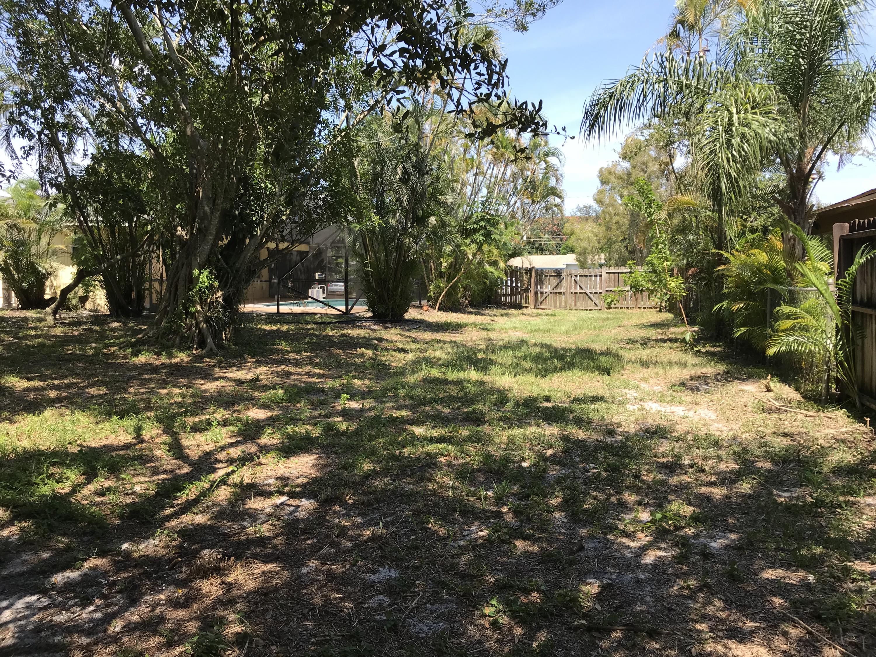 14827 Whatley Road Delray Beach, FL 33445 - Photo 9 of 36 a backyard of a house with table and chairs