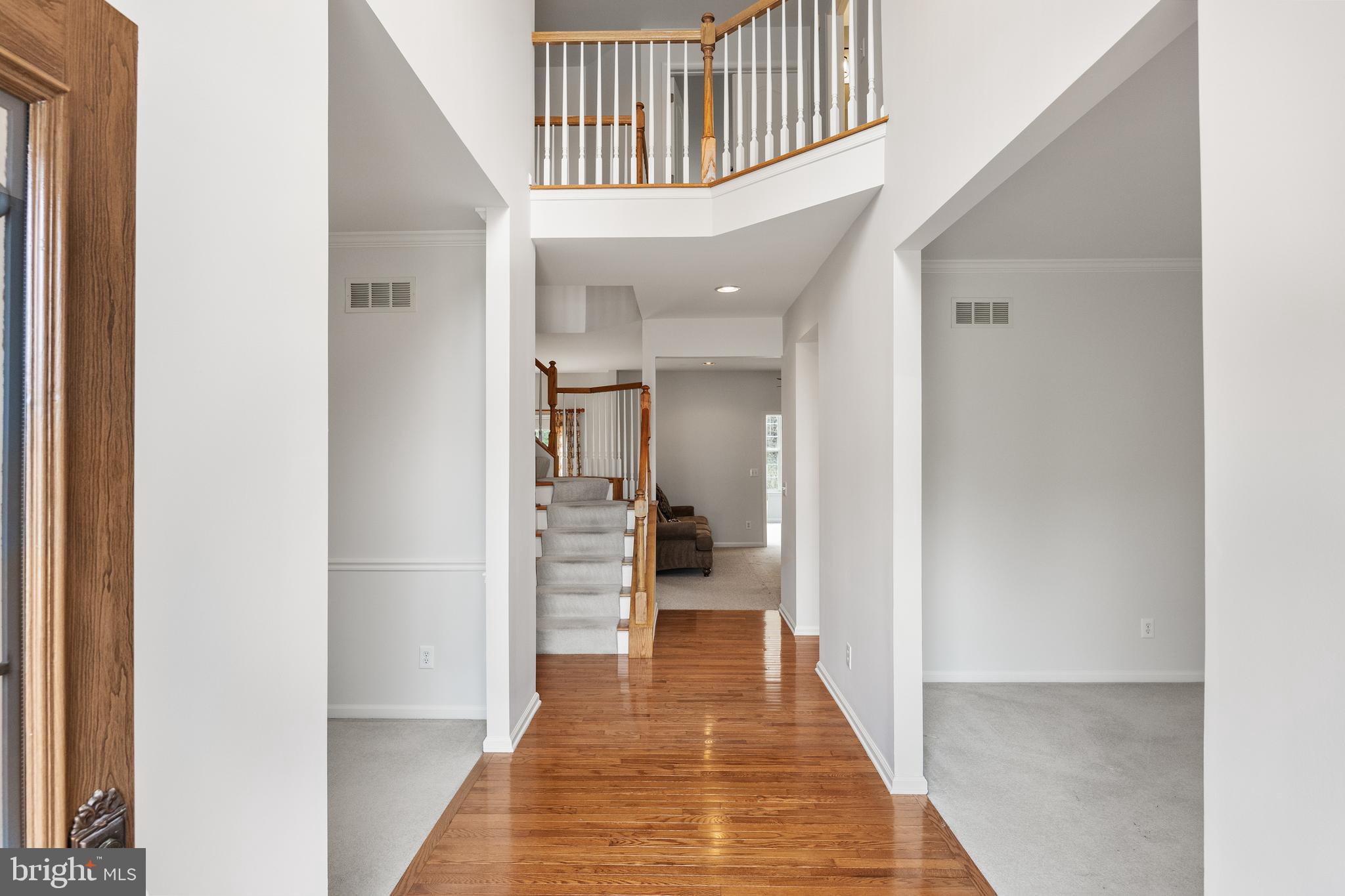 49 Cranberry Lane Delran, NJ 08075 - Photo 13 of 33 a view of a hallway with wooden floor and staircase
