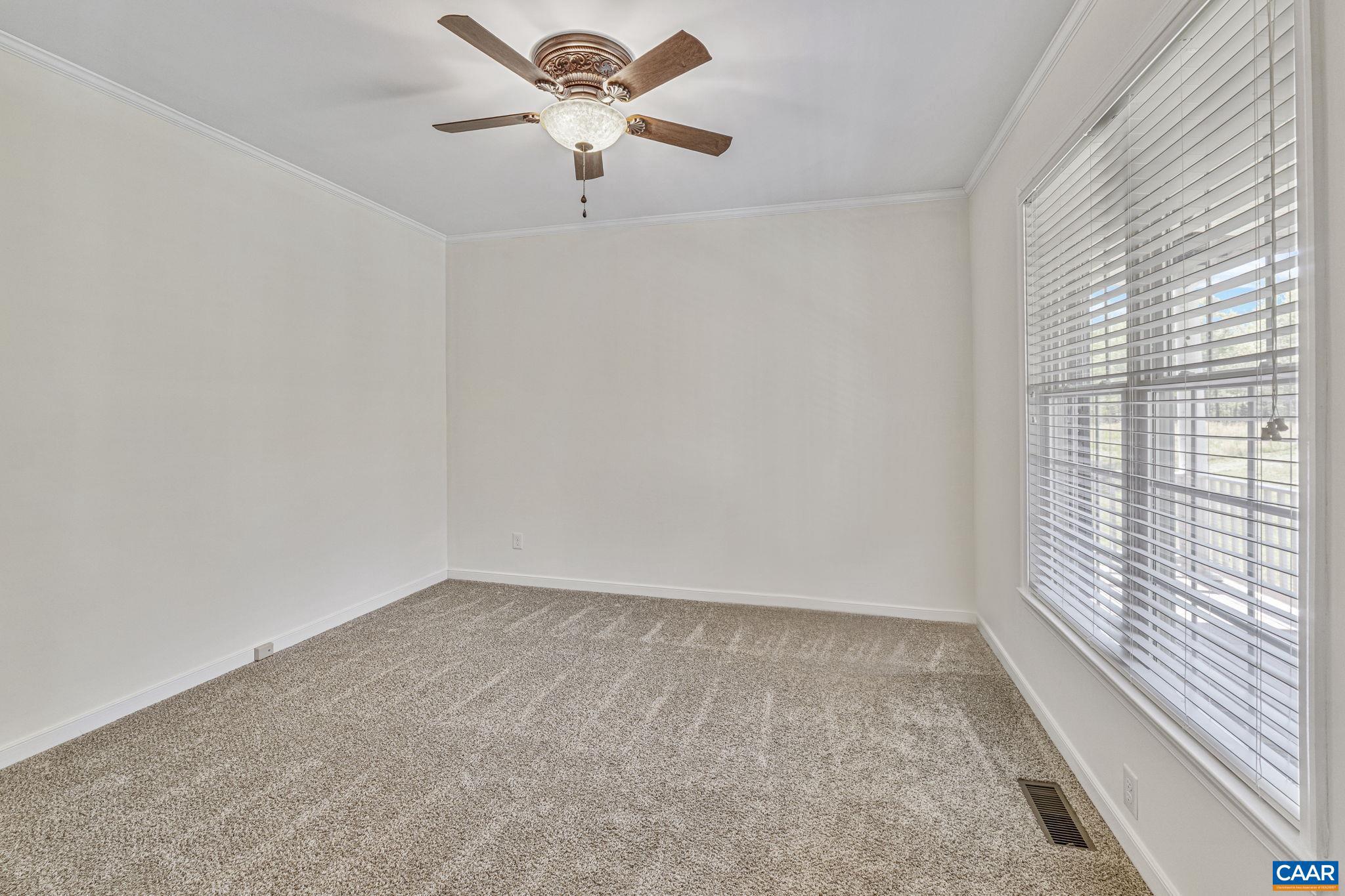 1130 Race Ground Road Rochelle, VA 22738 - Photo 12 of 58 an empty room with a window and a fan
