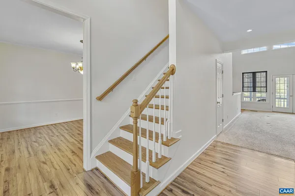 a view of a room with wooden floor and a gate