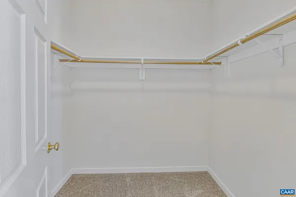 a view of a room with wooden floor and windows