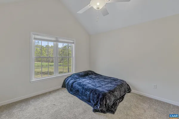 a view of a house with backyard and trees