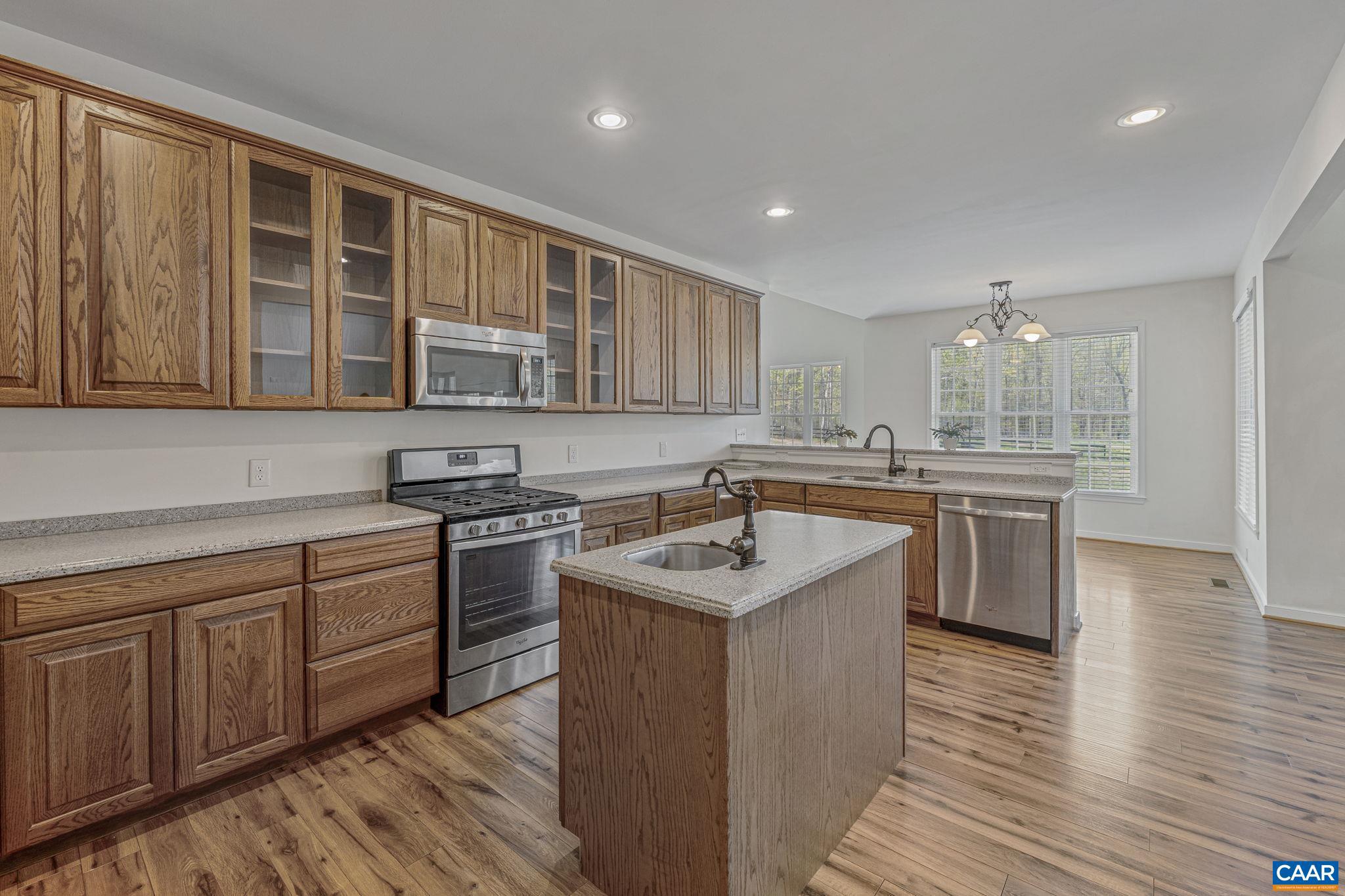 1130 Race Ground Road Rochelle, VA 22738 - Photo 8 of 58 a kitchen with stainless steel appliances granite countertop wooden cabinets sink and stove top oven