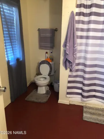 a bedroom with two beds and a chair