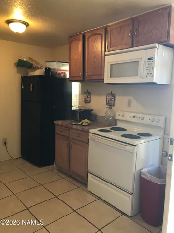 a utility room with stainless steel appliances a counter space and a window