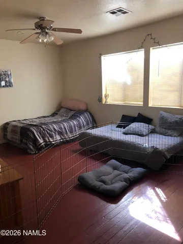 a bedroom with furniture and a flat screen tv