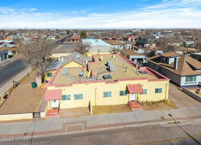 an aerial view of residential houses with city view