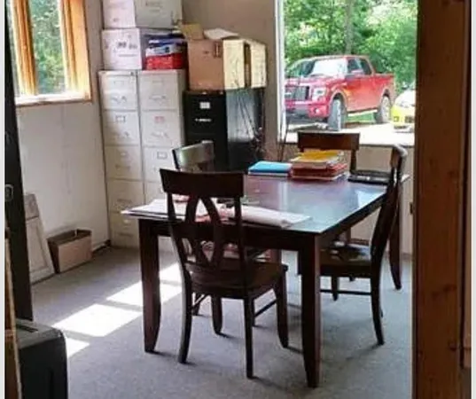 a kitchen with a refrigerator and cabinets