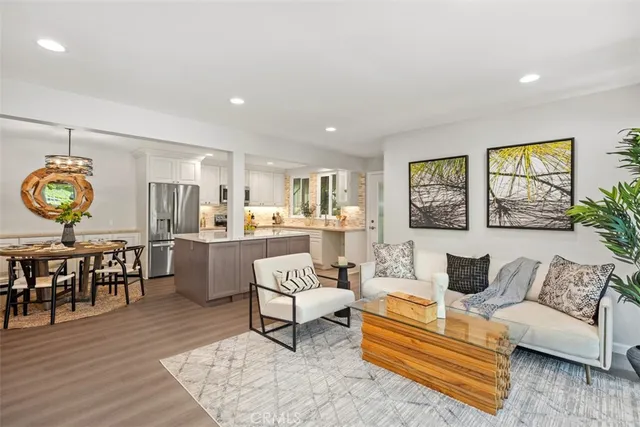 a living room with furniture and kitchen view