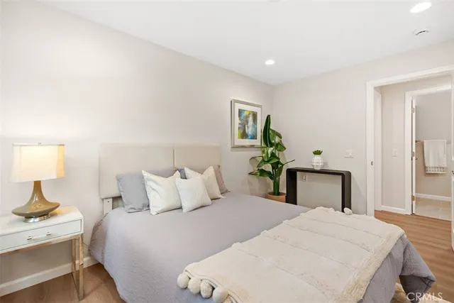 a bedroom with a bed and a potted plant
