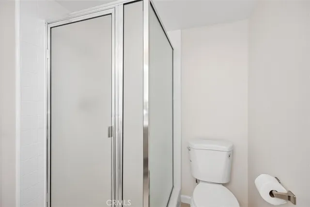a white toilet sitting next to a bathroom sink
