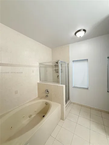a bathroom with a bathtub and shower