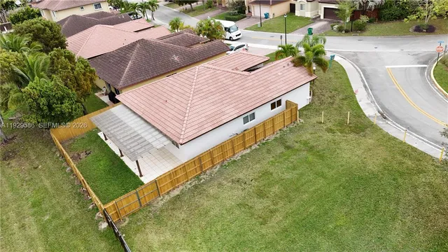 an aerial view of a house with a yard