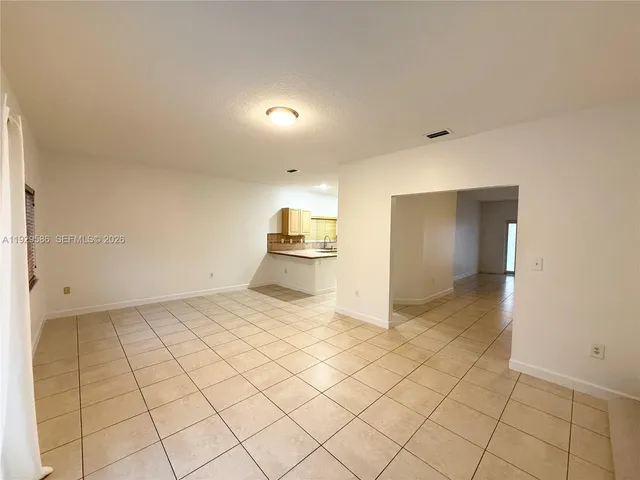 a view of a refrigerator and more cabinets