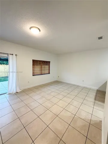 a view of a room with a projector and cabinets