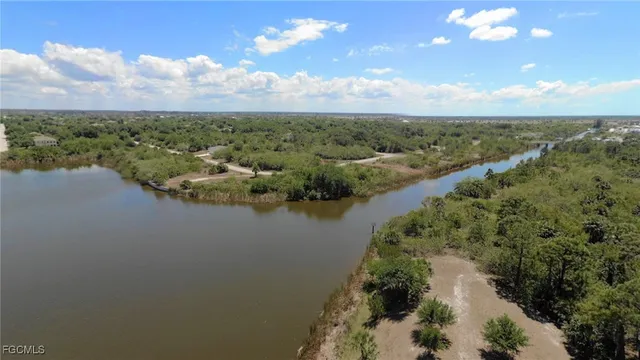 a view of a lake with houses in back