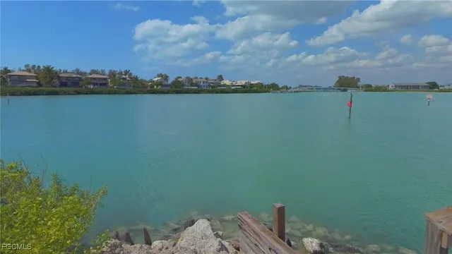 a view of a lake with houses in the back
