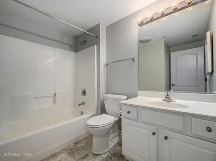 a bathroom with a sink toilet vanity and shower