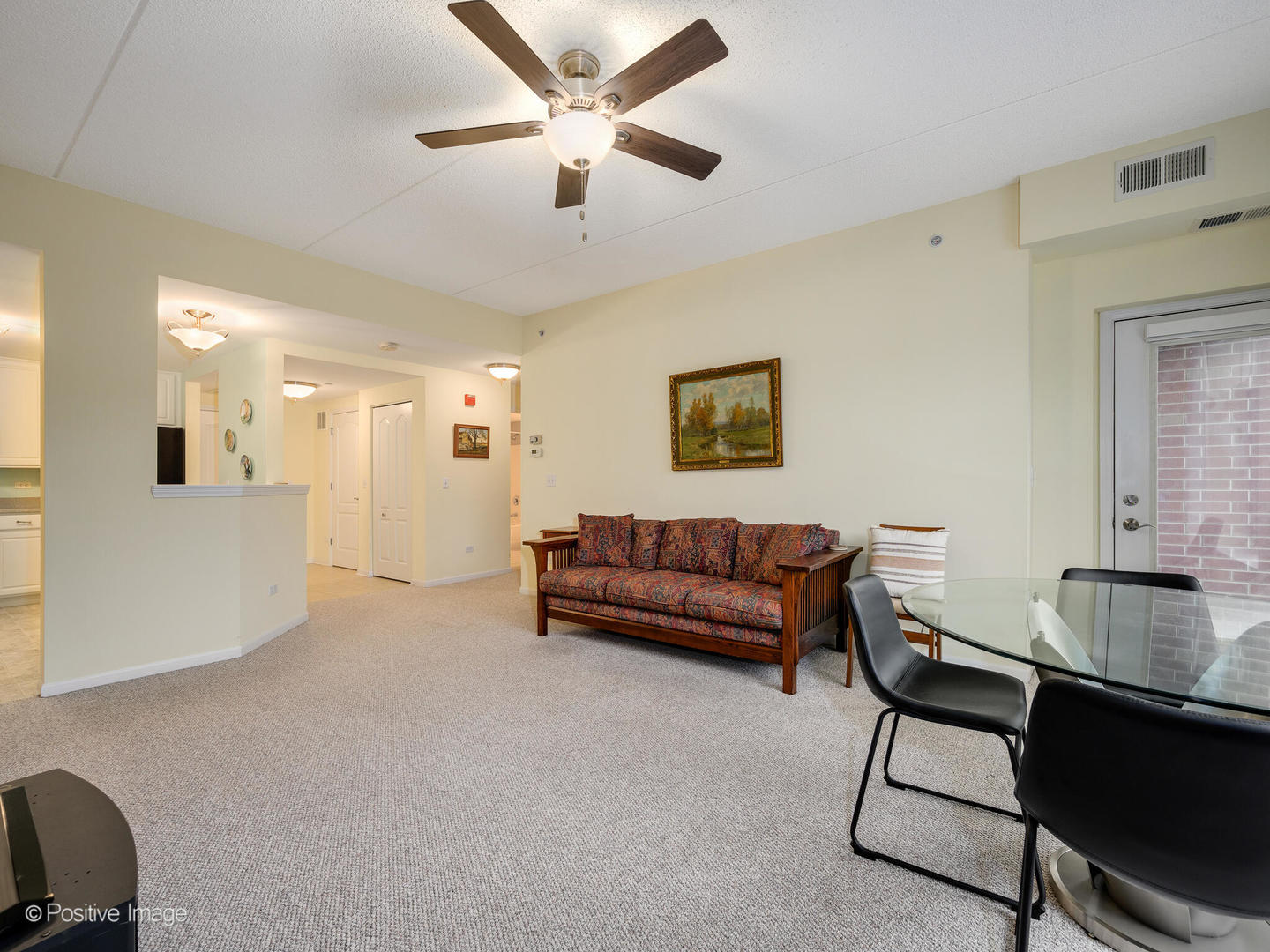 855 East 22nd Street, Unit 217 Lombard, IL 60148 - Photo 7 of 27 a living room with furniture and a ceiling fan