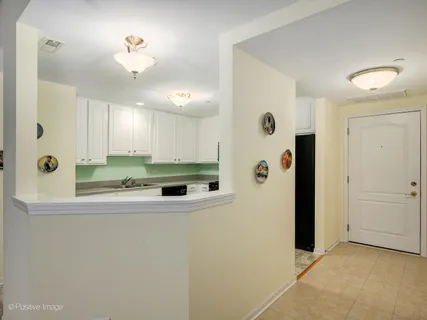 a view of a livingroom with kitchen appliances