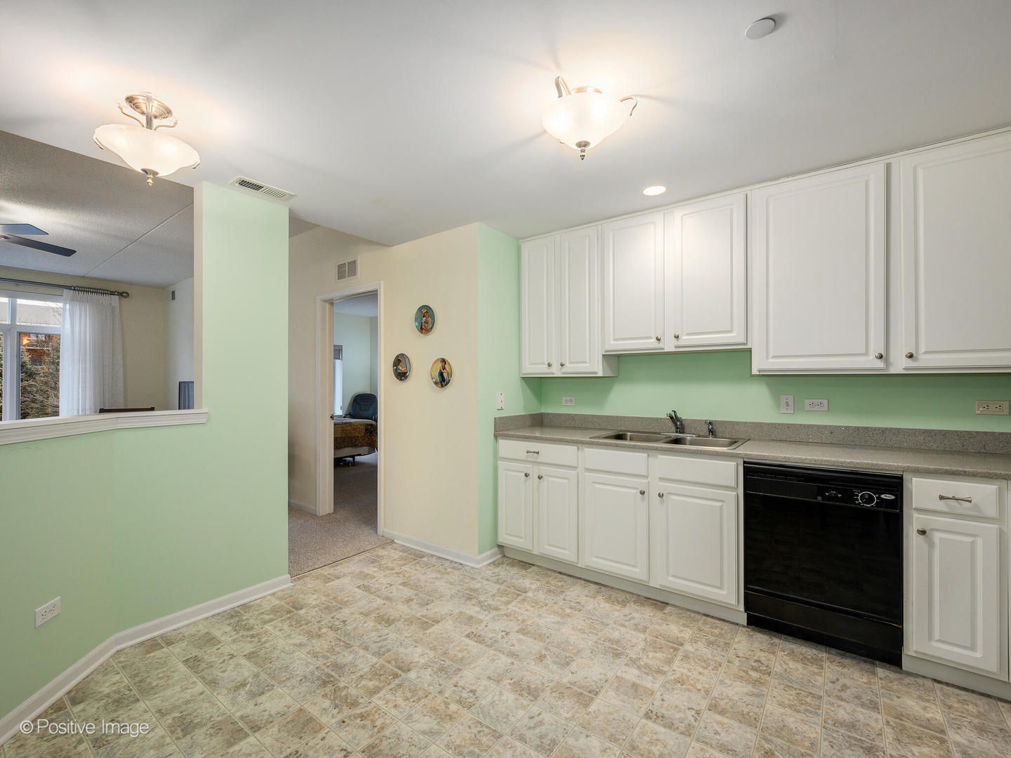 855 East 22nd Street, Unit 217 Lombard, IL 60148 - Photo 10 of 27 a kitchen with granite countertop a sink and cabinets